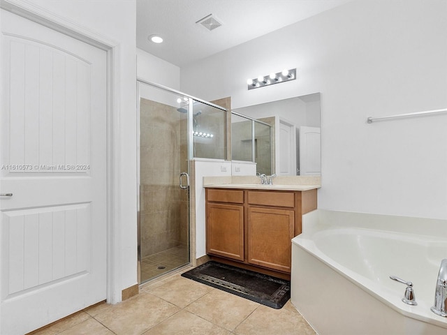 bathroom with vanity, independent shower and bath, and tile patterned floors