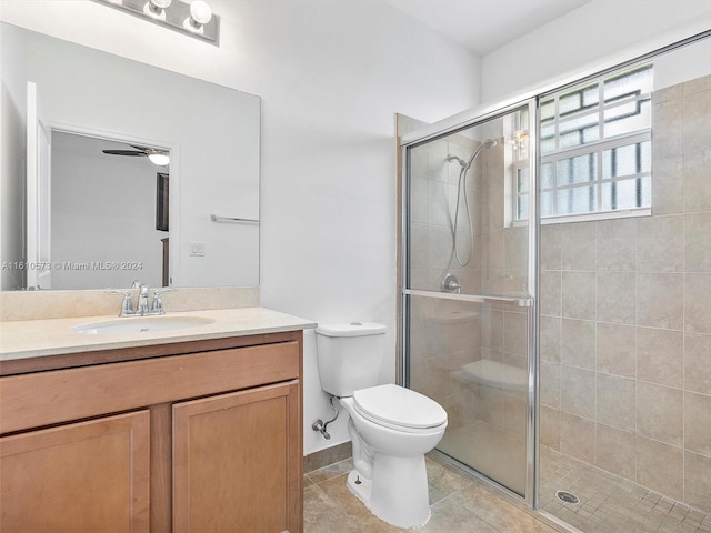 bathroom featuring toilet, an enclosed shower, and vanity