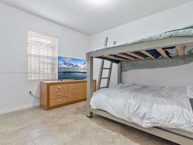 bedroom featuring light tile patterned floors