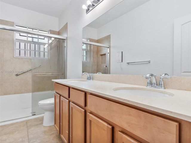 bathroom with toilet, walk in shower, vanity, and tile patterned floors