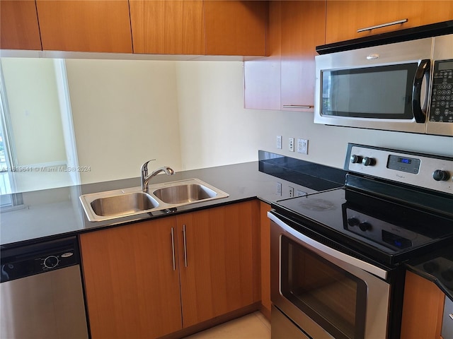 kitchen with sink and appliances with stainless steel finishes