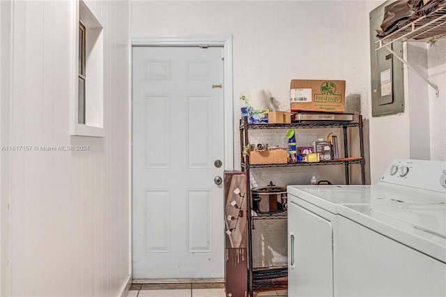 clothes washing area with washing machine and clothes dryer and light tile patterned floors