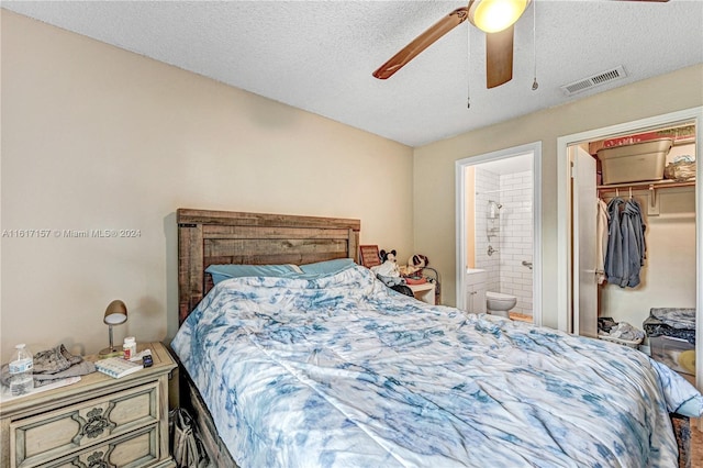 bedroom with ceiling fan, connected bathroom, a closet, and a textured ceiling