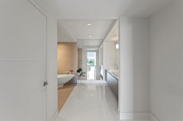 bathroom featuring vanity, tile patterned floors, and a bathing tub