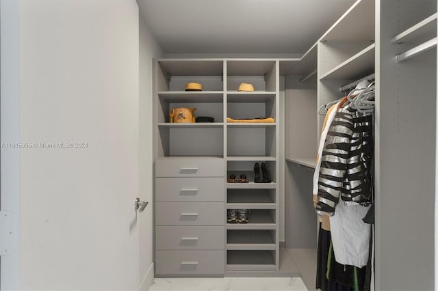 spacious closet with light tile patterned flooring