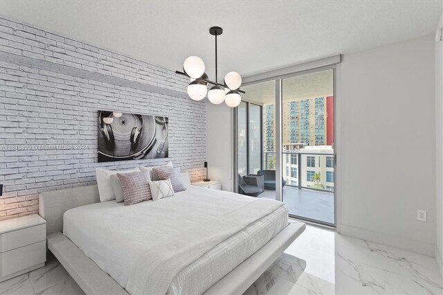 tiled bedroom featuring brick wall, a wall of windows, an inviting chandelier, and access to exterior