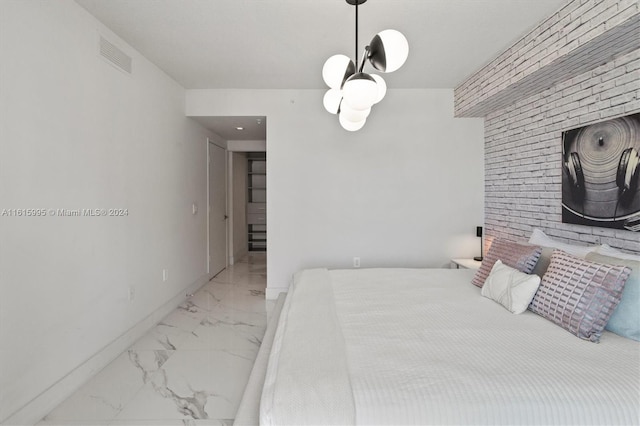 bedroom with brick wall and tile patterned floors