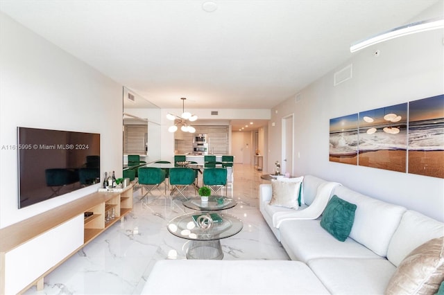 tiled living room with a notable chandelier