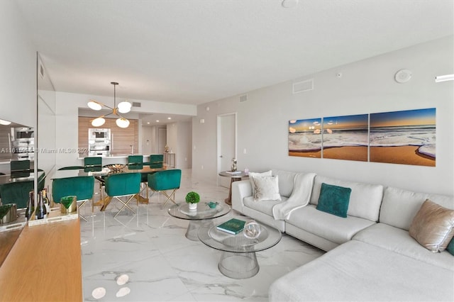 living room featuring a chandelier and light tile patterned floors