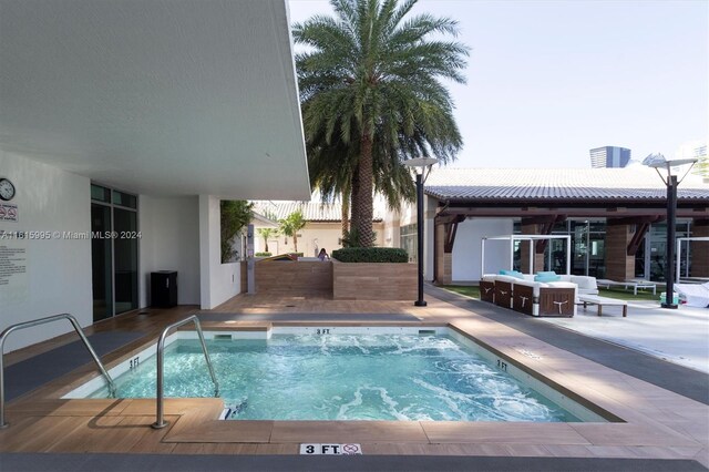 view of swimming pool with a patio area and an in ground hot tub