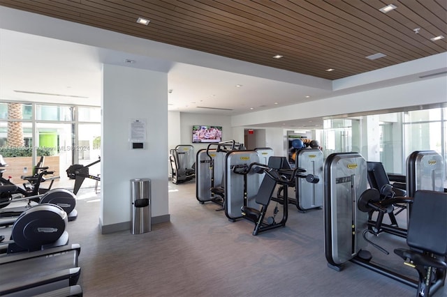 workout area featuring a wall of windows and wood ceiling