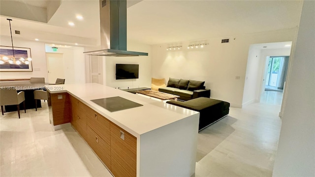 kitchen featuring black electric stovetop, a center island, pendant lighting, and range hood