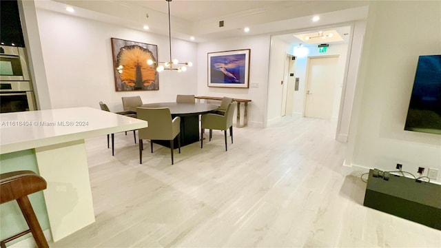 dining area featuring a notable chandelier and wood-type flooring