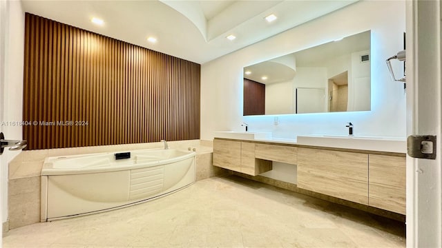 bathroom featuring vanity, tile patterned floors, and a washtub