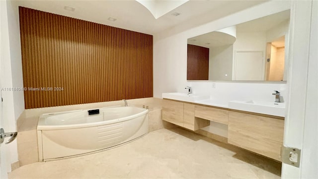 bathroom featuring vanity and a tub to relax in