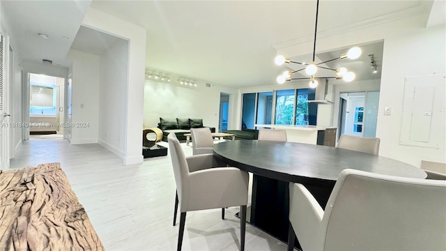 dining area featuring a notable chandelier and light hardwood / wood-style floors