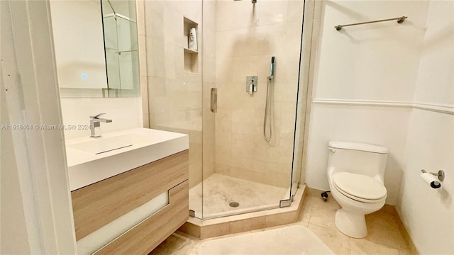 bathroom featuring vanity, a shower with shower door, toilet, and tile patterned flooring