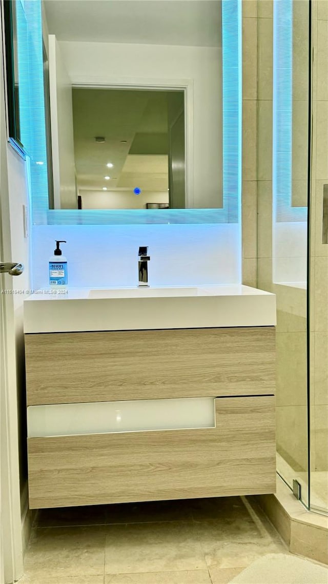 bathroom with vanity, tile patterned floors, and an enclosed shower