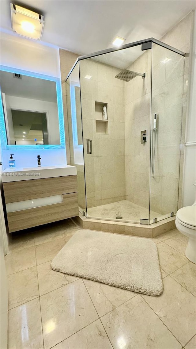 bathroom featuring vanity, toilet, and walk in shower