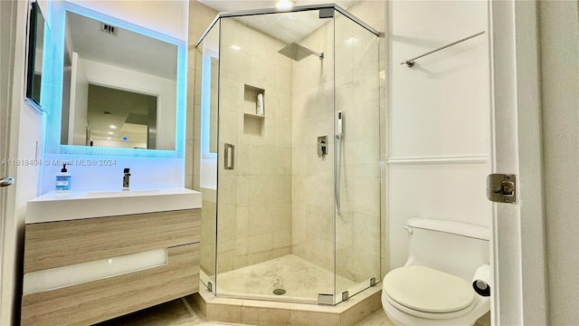 bathroom featuring vanity, toilet, and walk in shower