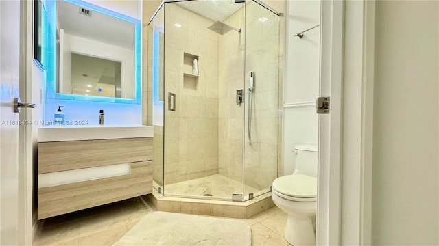 bathroom with toilet, walk in shower, vanity, and tile patterned floors