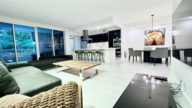 living room with a chandelier and sink