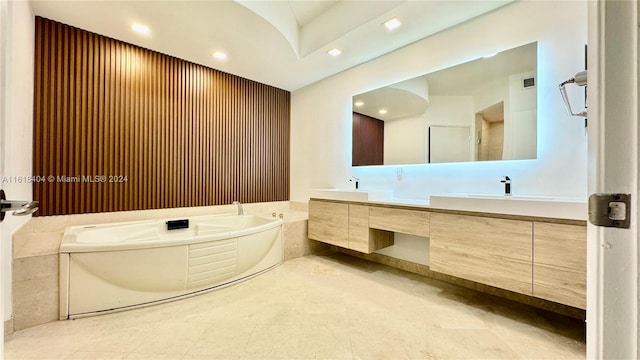 bathroom with vanity, a tub to relax in, and tile patterned flooring