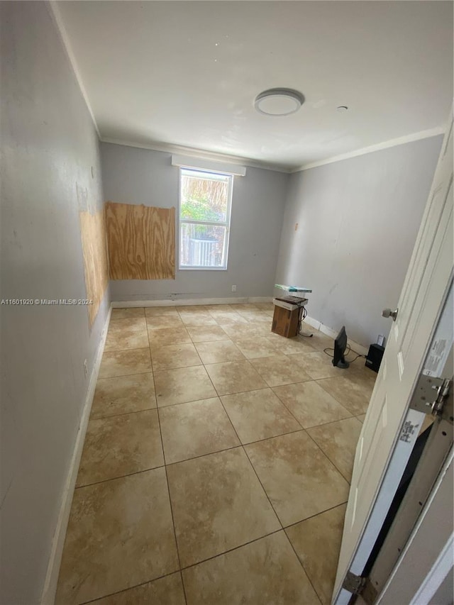 1926 Ramsey Dr, Lake Worth, FL 33461 - empty room featuring light tile patterned floors and crown molding
