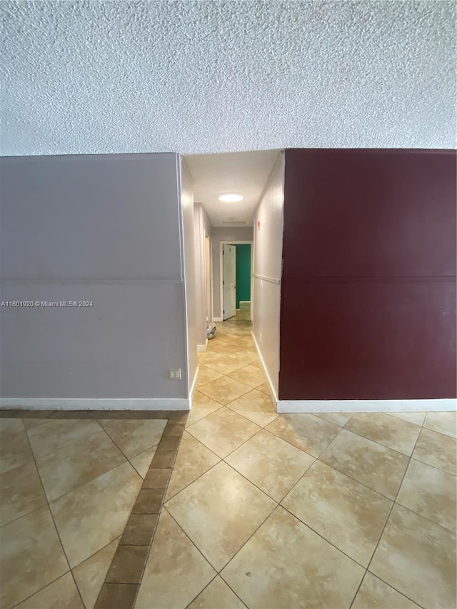 hall featuring light tile patterned floors