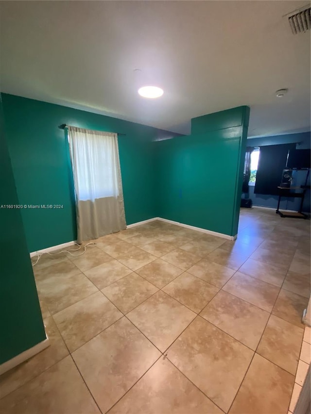 unfurnished room featuring tile patterned floors