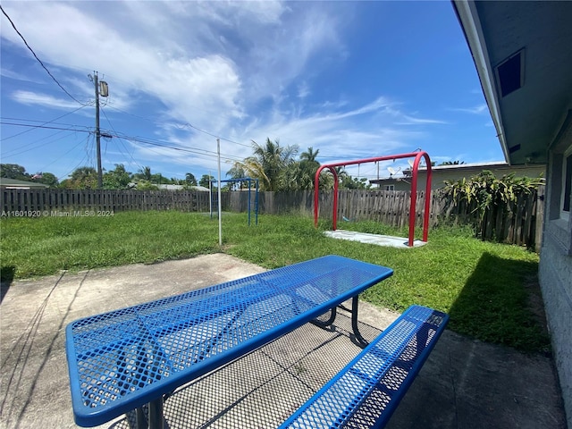 view of swimming pool featuring a patio and a yard