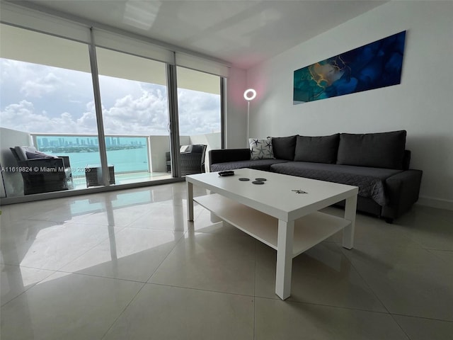 living area with light tile patterned floors and a wall of windows