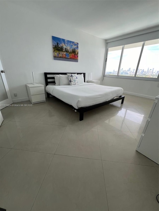 unfurnished bedroom featuring baseboards and tile patterned floors