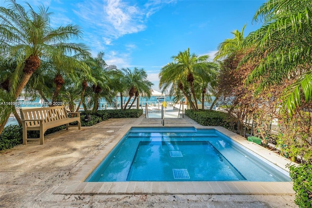 view of swimming pool with a water view