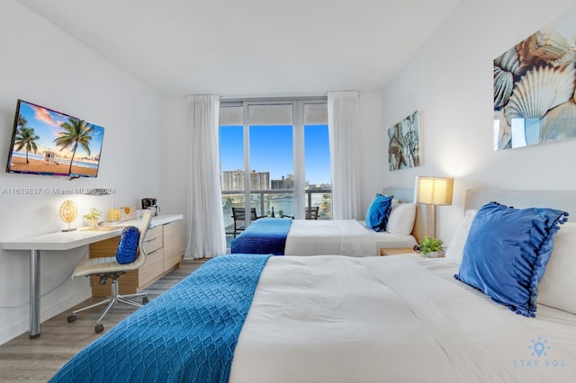 bedroom featuring light hardwood / wood-style floors and access to outside