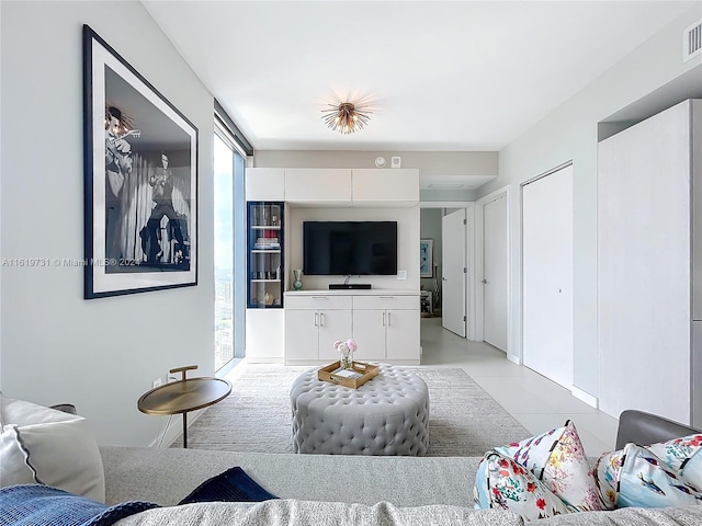 living room with plenty of natural light and light tile patterned flooring