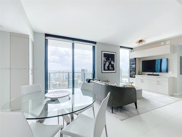 tiled dining space featuring expansive windows