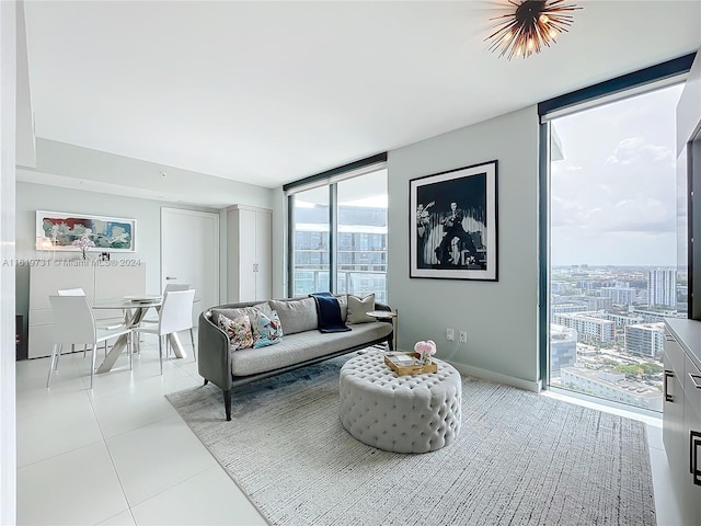 living room with floor to ceiling windows and light tile patterned floors