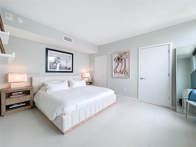 bedroom with light tile patterned floors