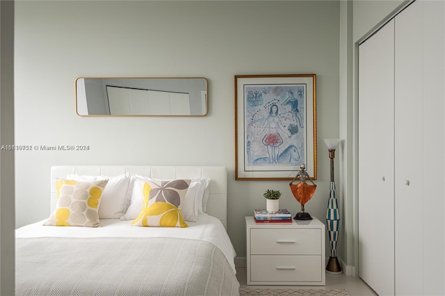 bedroom with a closet and tile patterned flooring