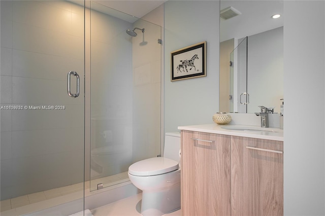 bathroom featuring toilet, vanity, and an enclosed shower