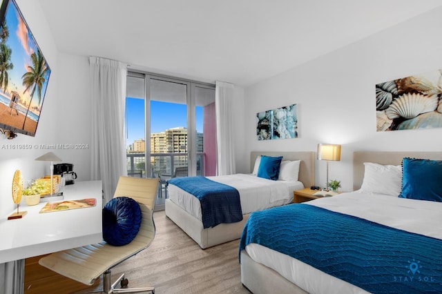 bedroom featuring access to outside and light hardwood / wood-style flooring