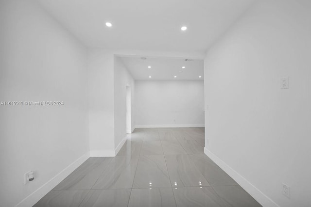 hall with light tile patterned floors