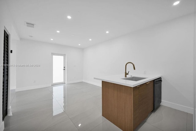 kitchen with sink, kitchen peninsula, dishwasher, and light tile patterned floors