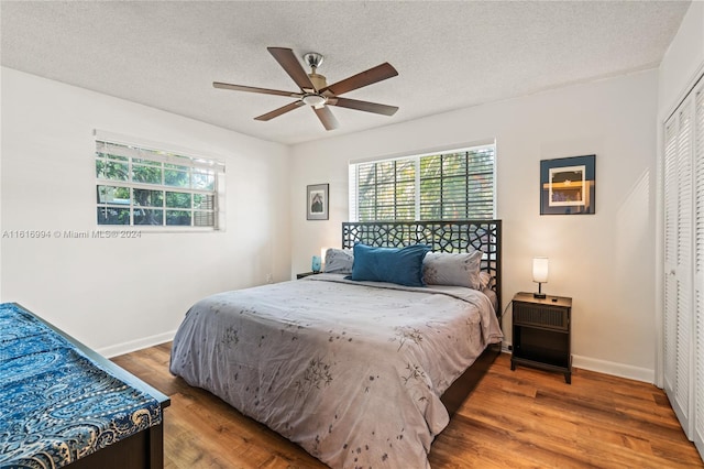 bedroom with ceiling fan, a closet, and wood-type flooring