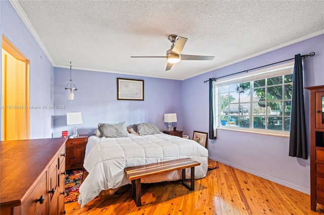 bedroom featuring light wood-type flooring, ceiling fan, crown molding, and a textured ceiling