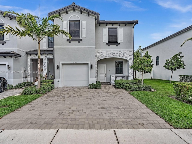 view of front of property with a garage and a front lawn