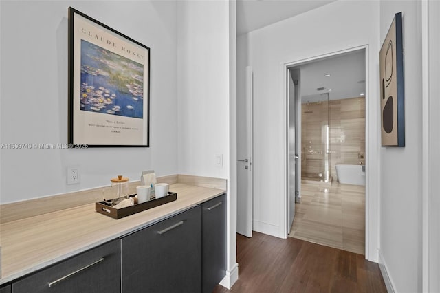 bathroom featuring a shower, a soaking tub, wood finished floors, and vanity