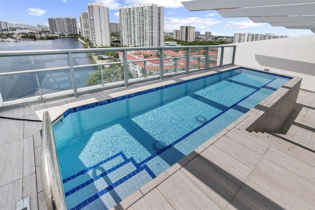 view of pool featuring a city view and a water view