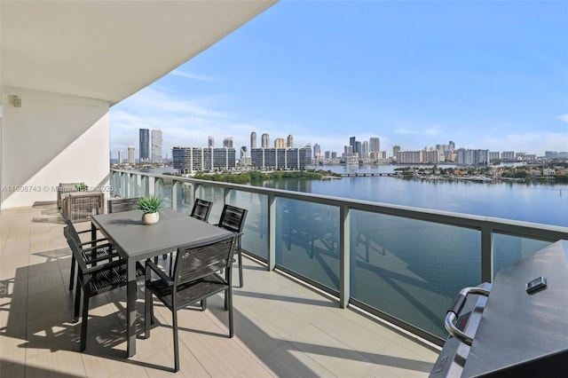 balcony featuring a water view and a city view